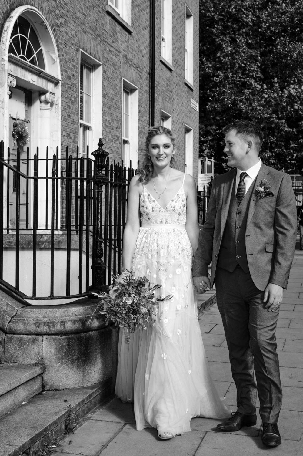 Wedding photographer in Dublin photographs the bride and groom pictured walking through Georgian Dublin 