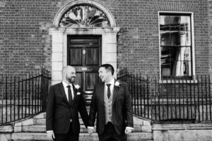 Two grooms photographed in front of Georgian doors on Merrion Road in Dublin during their LGBT Gay Wedding