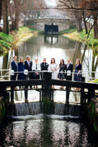 A couple photographed with their families standing on the lock crossing the Grand Canal during their LGBTQ Dublin Wedding