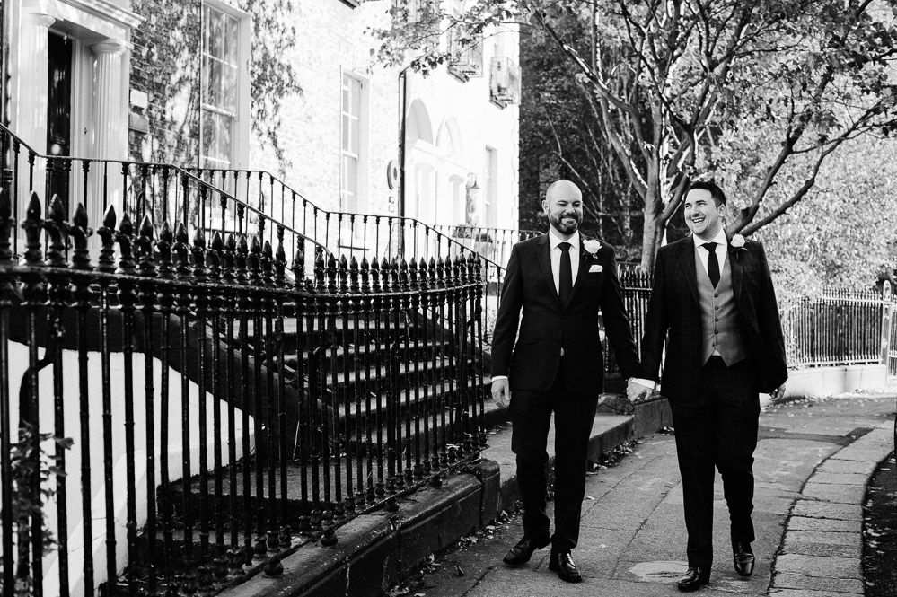 LGBTQ Wedding Photographer photographs two grooms walking through Georgian Dublin on their wedding day. 