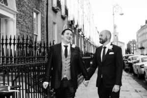 LGBTQ Wedding Photography of two grooms walking through Georgian Dublin after being married at the Dublin registry office.
