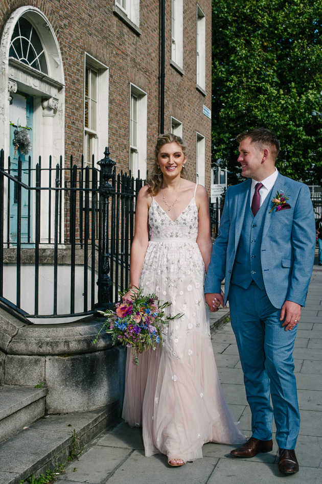 Micro wedding photograph of the bride and groom walking through Georgian Dublin