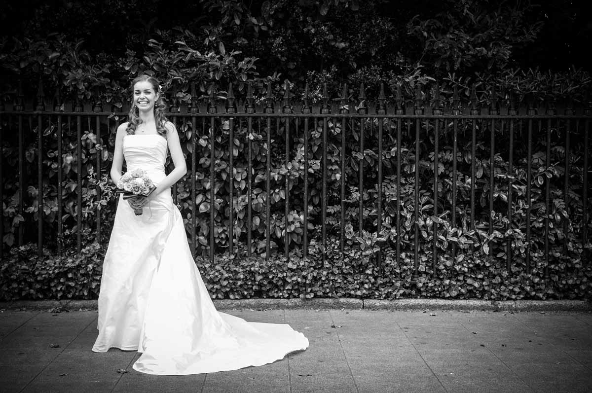 The bride poses for a wedding photograph by St.Stephen's Green in Dublin before her Fallon & Byrne Wedding Ceremony