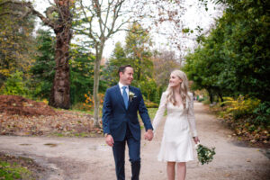 The bride and groom take a walk through Merrion Square Park hand in hand before their Merrion Hotel wedding