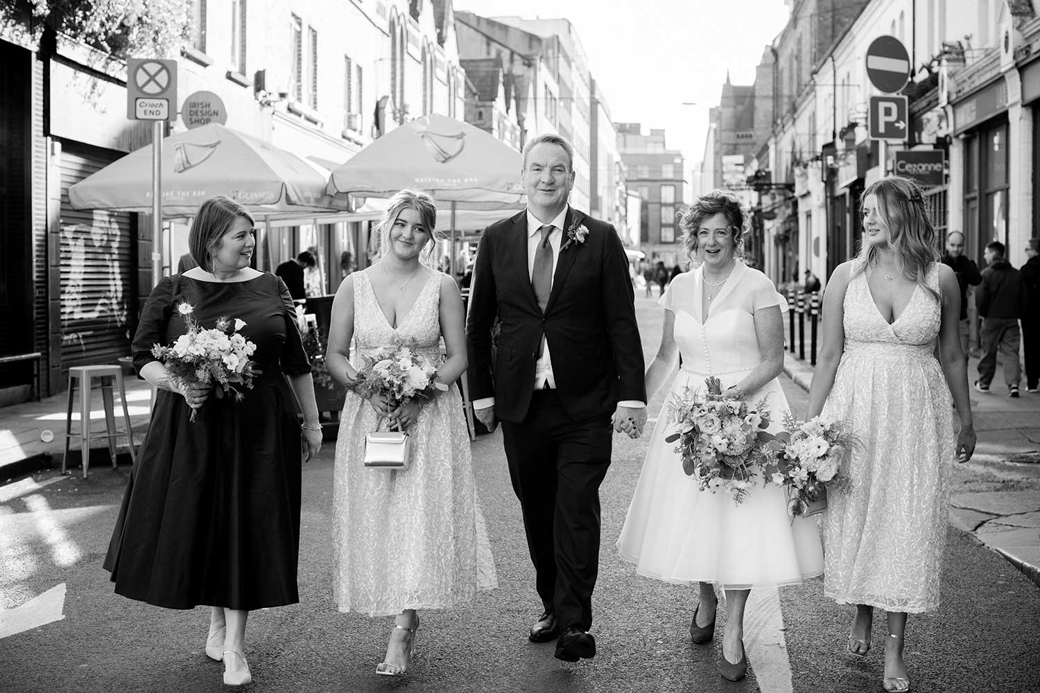 The bridal party walk through the streets of Dublin following their City Assembly House Wedding in Dublin